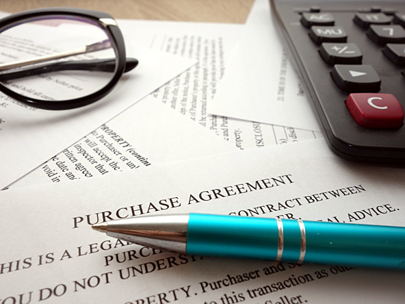 Calculator, pen, glasses and contract